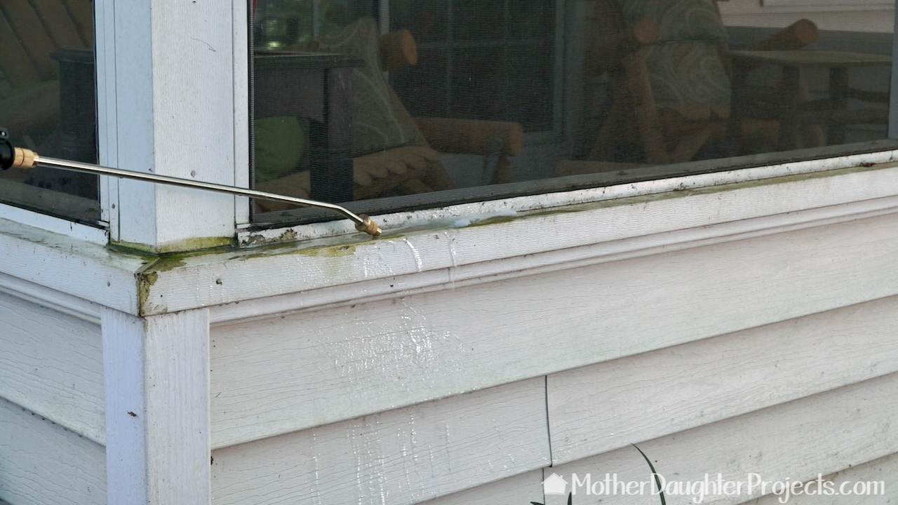 Spraying the green algae on the outside of the porch. 