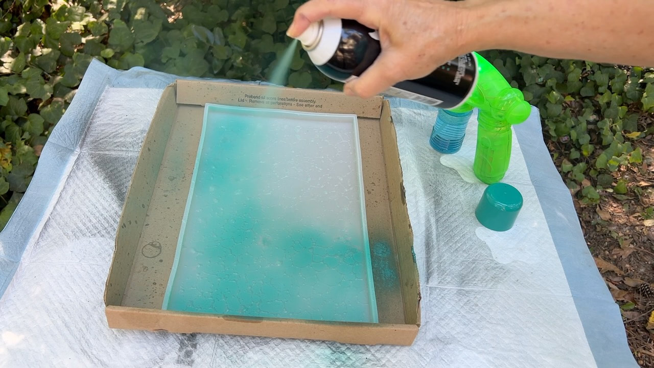 Adding color to the epoxy tray with Behr spray paint in Tropics.
