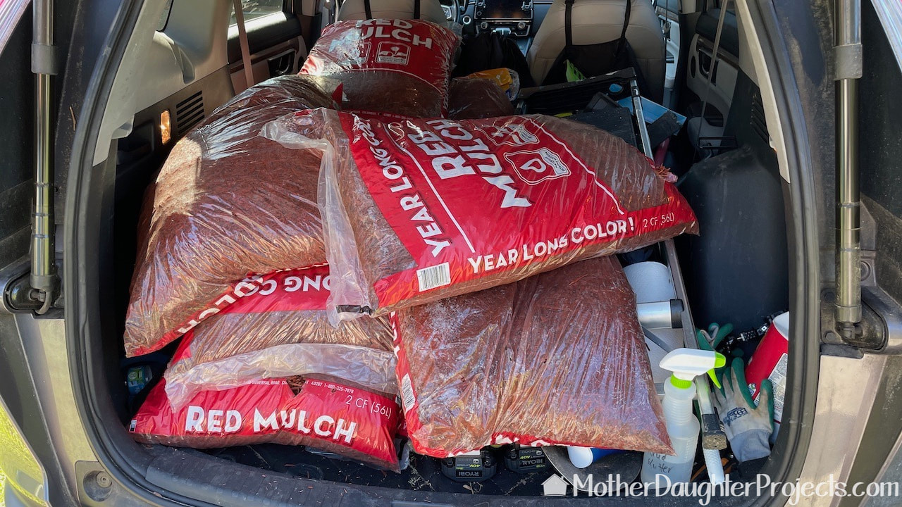 Picking up bags of red mulch from the garden department at Wal-Mart.