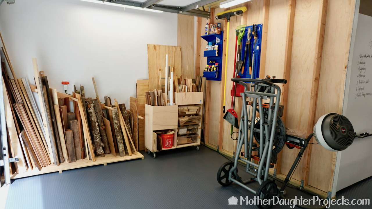 The wood storage zone in the garage with the Ridgid miter saw on a Ridgid movable stand. 