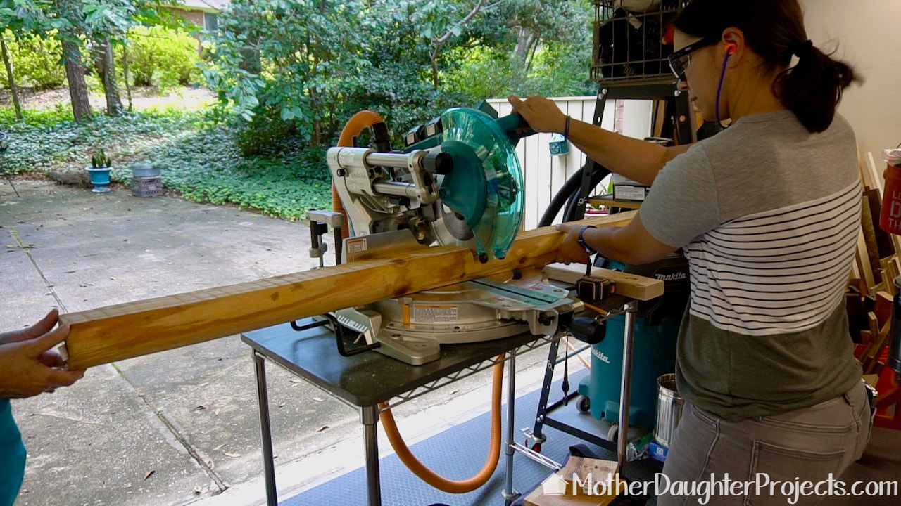 Cutting the landscape timbers for the kayak stand to length on the miter saw.