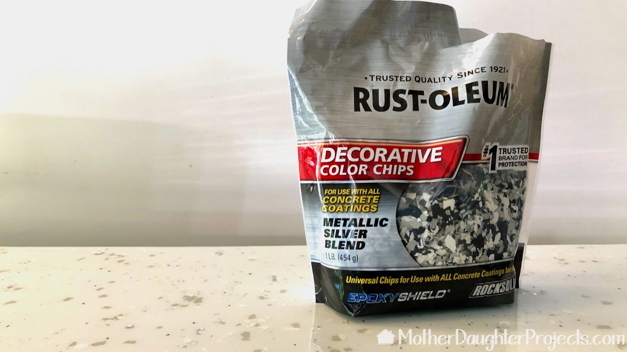 Using Rust-Oleum decorative color chips in Glacier Grey Blend makes the countertop look like quartz.