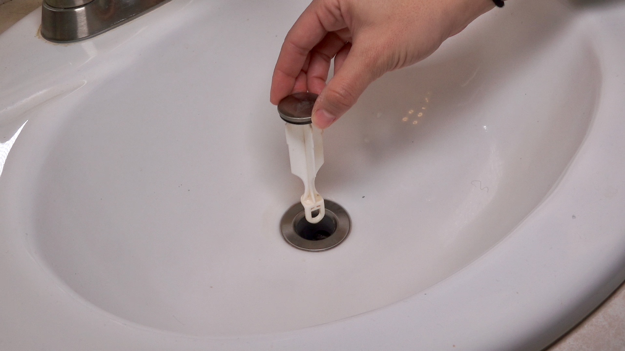 removing clogs from a bathroom sink