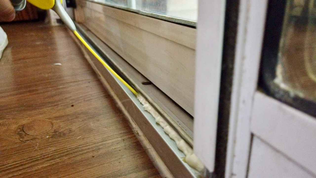 Using WD-40 Specialist spray to lubricate the sliding glass door track.