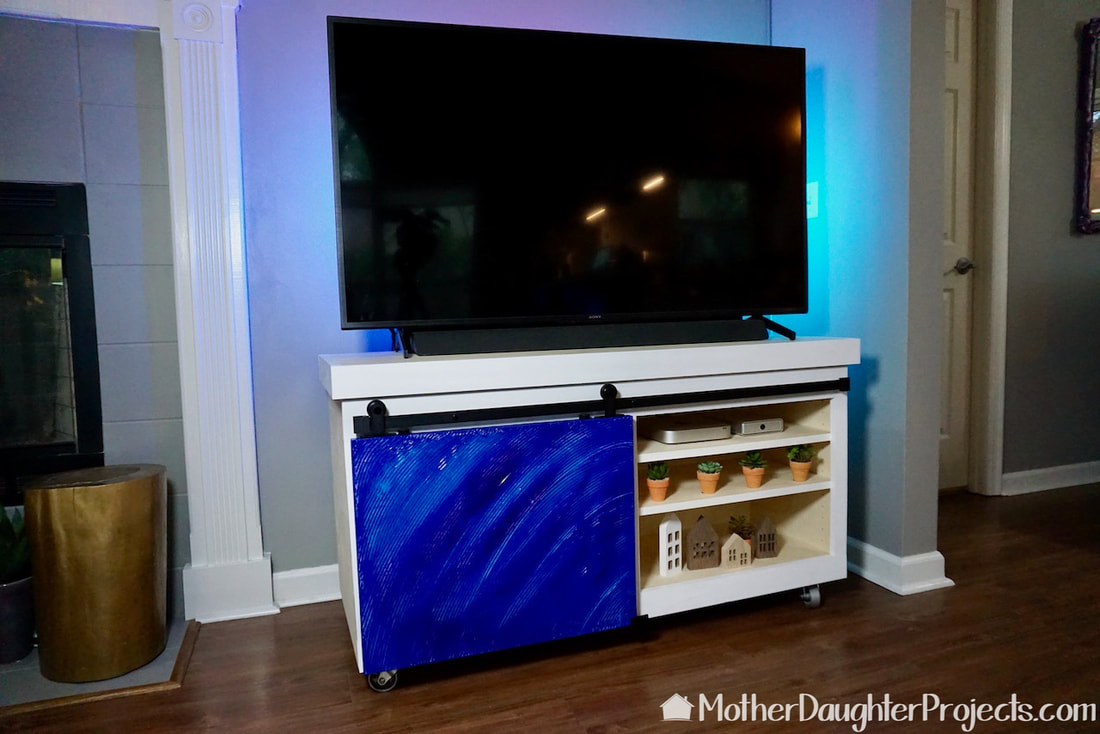 The TV stand in place with colorful sliding door. 
