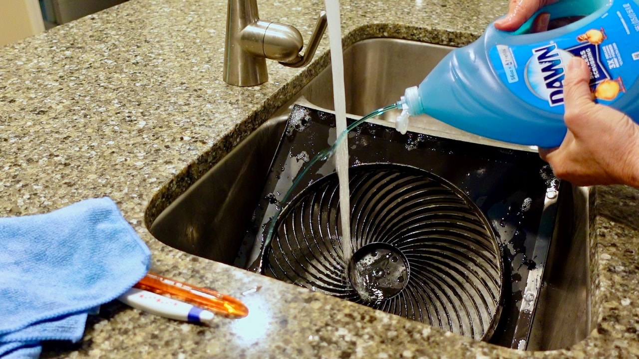 Cleaning the Vornado tilting panel model number 279T. Washing the front panel in the sink with Dawn dishwashing liquid.