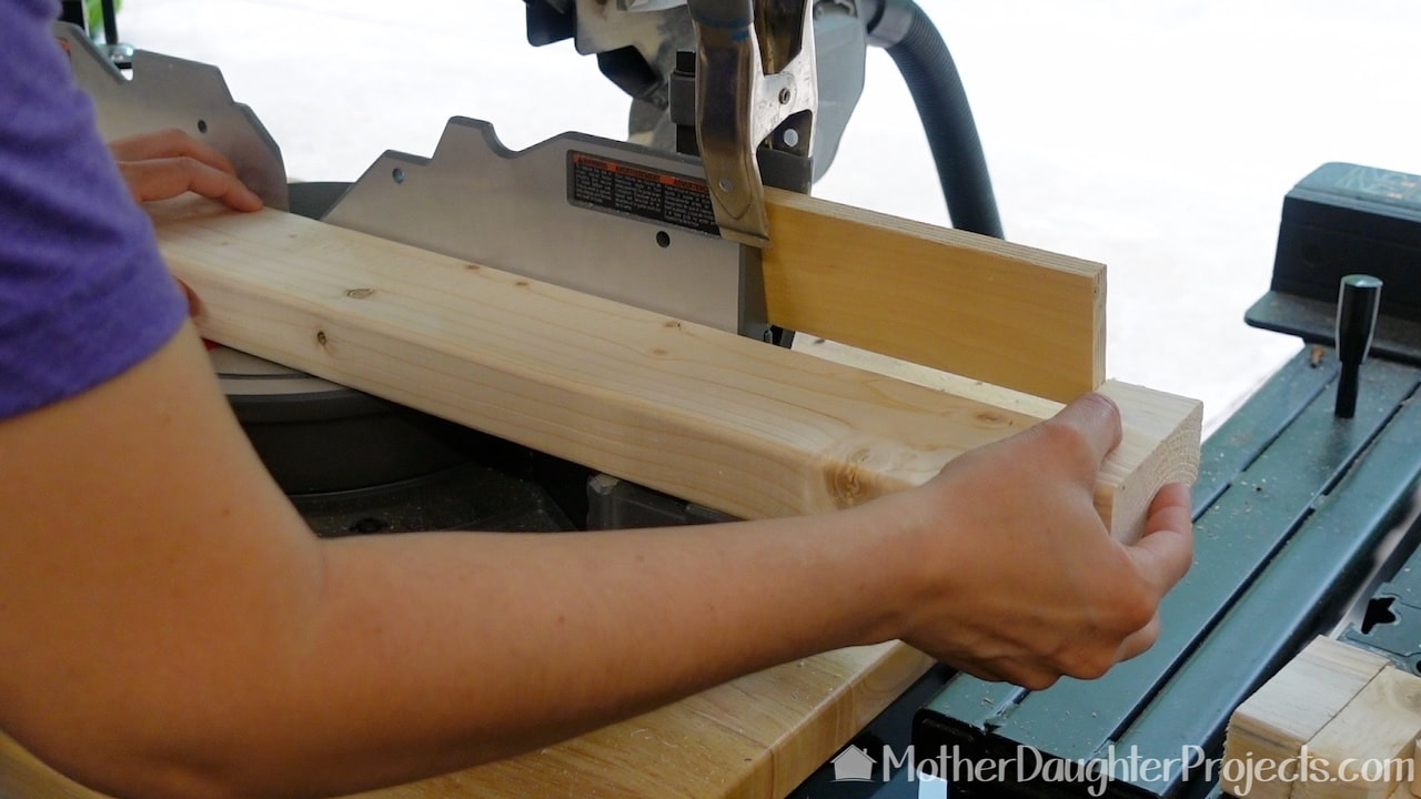 Cut the slatted bench legs on the miter saw.